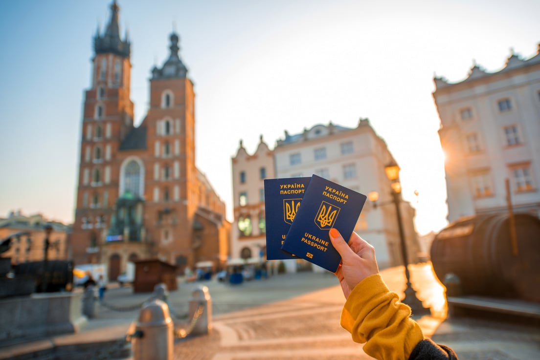 Female Hands Holding Ukrainian Passports